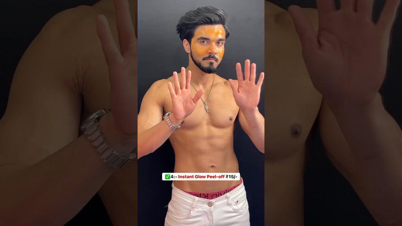 Vyras be marškinėlių su geltonu veido kauke rankas laiko pakeltas, reklamuoja produktą.