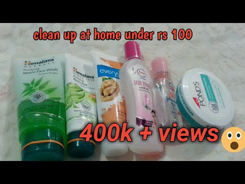 Veido prausikliai ir kremas ant užuolaidos fono, viršuje užrašas „clean up at home under rs 100“, apačioje „400k+ views“