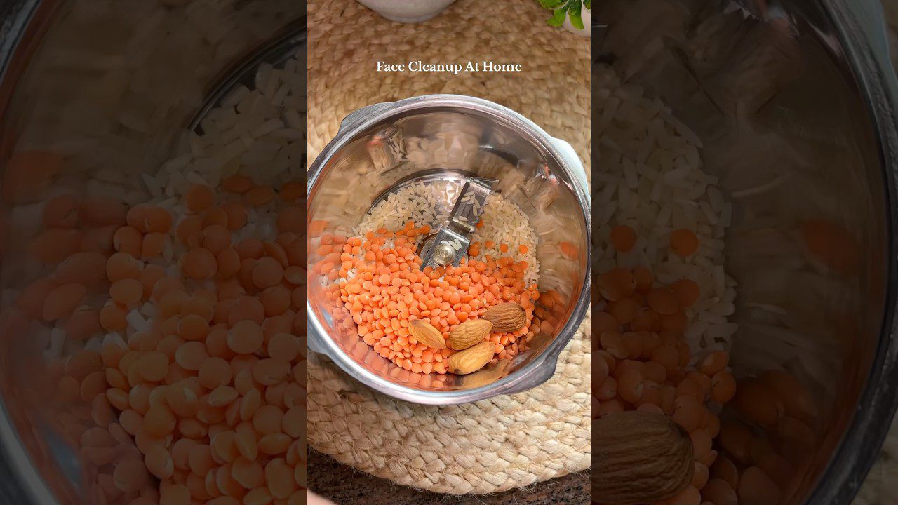 Metalinė trintuvo talpa su raudonais lęšiais, migdolais ir ryžiais ant pintos kilimėlio