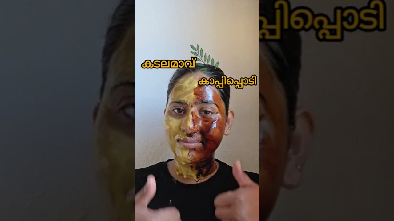 Moteris su dviem veido kaukėmis – kairė geltona, dešinė ruda, rodo du nykščius