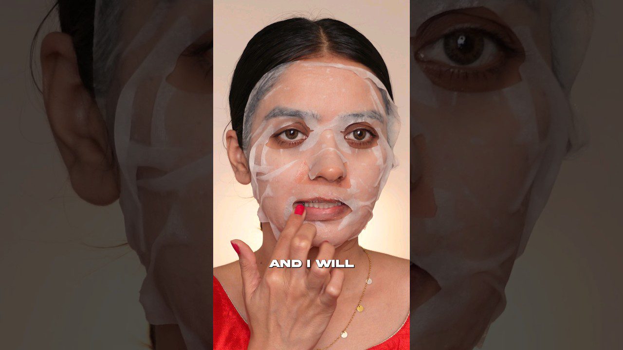 Moteris su drėkinamąja lakštine veido kauke, braukanti pirštu per lūpas, tekstas „AND I WILL“