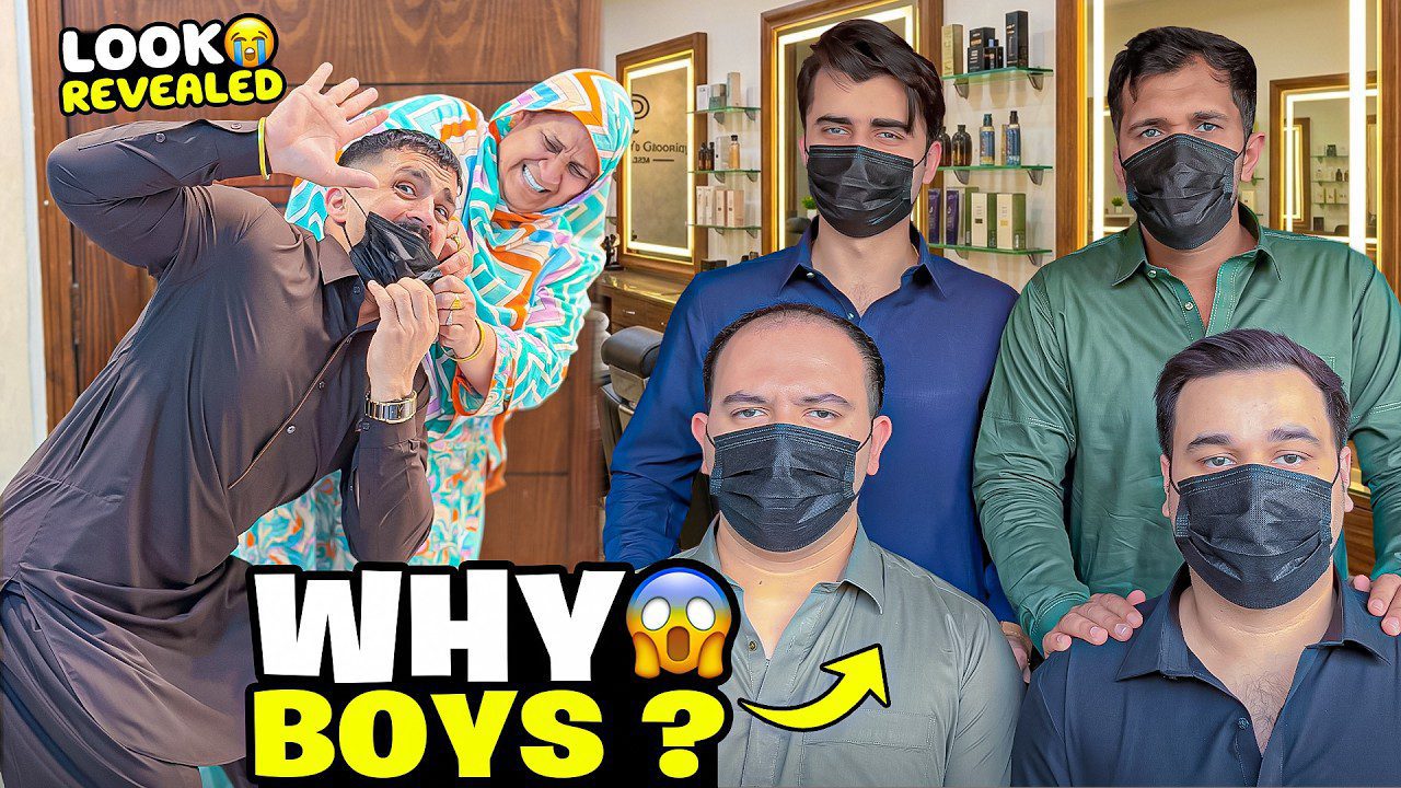 Penki jauni vyrai su juodomis kaukėmis salone, šone juokiasi moteris su galvos apdaru