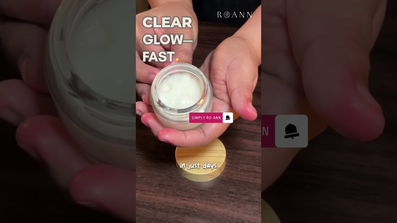 Rankose laikomas atidarytas veido kremas su baltu losjono konsistencija ir mediniu dangteliu.