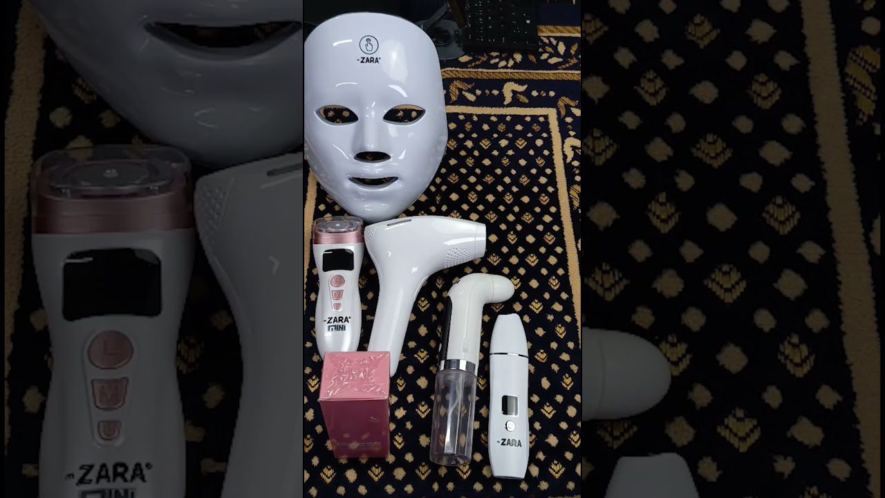 LED veido kaukė, trys grožio prietaisai ir priedai ant ornamentuoto kilimėlio