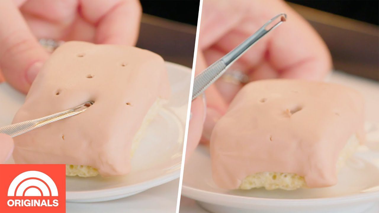 Rankos formuoja mažų duonos gabalėlių paviršiuje skylutes peiliuku ir pincetu, rožinis glajus ant pyragėlio