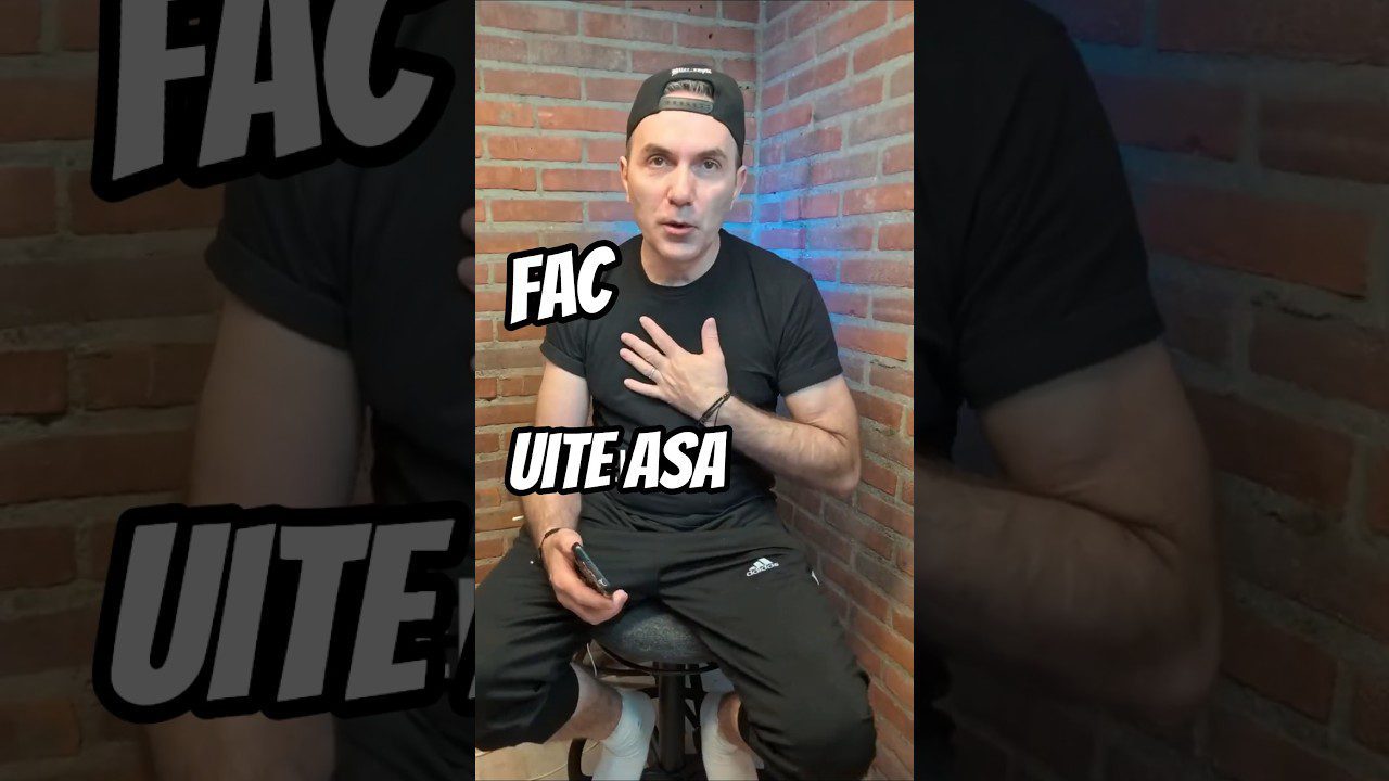 Vyras juodais drabužiais sėdi ant kėdės prie mūrinės sienos, laiko ranką ant krūtinės, teksto užrašas „FAC UITE ASA“.