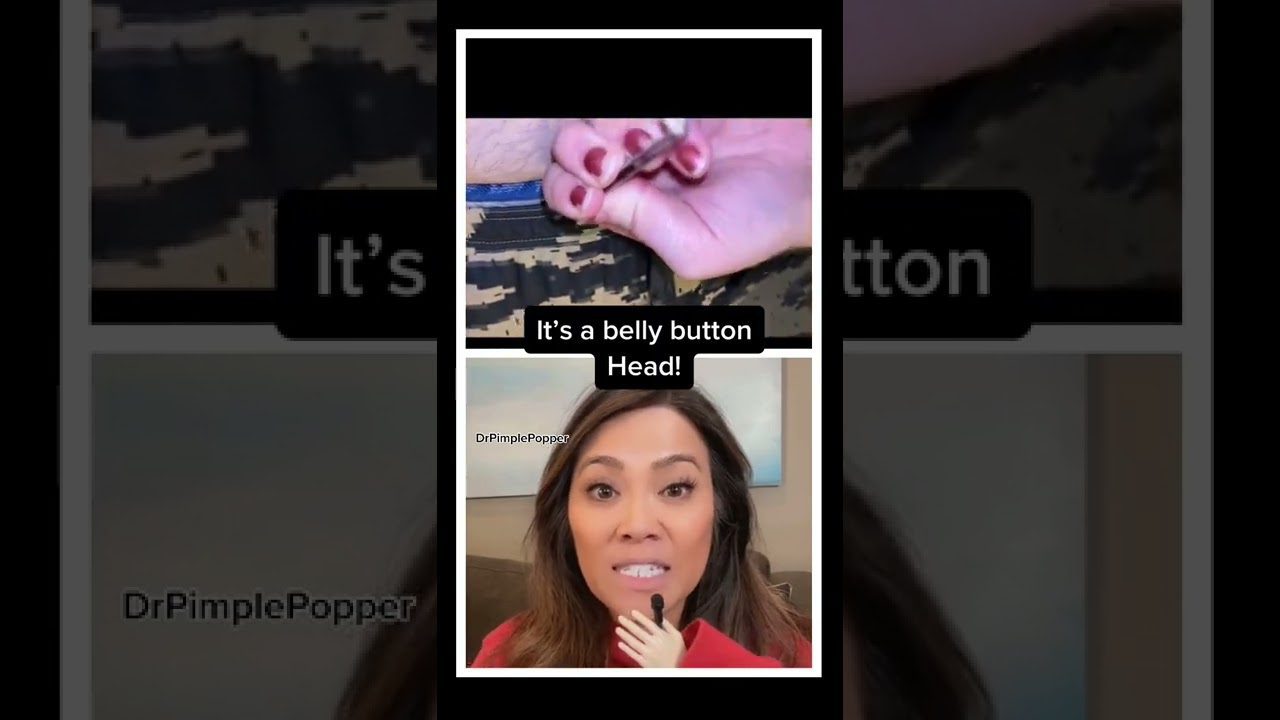 Moters veidas su mikrofonu ir viršuje ranka traukia iš pilvo mygtuko baltą iškilimą, tekstas: „It’s a belly button Head!“